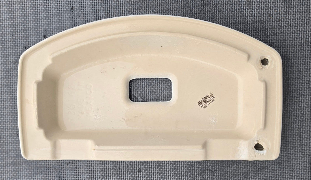 Underside of white American Standard 735168 dual-flush toilet tank lid