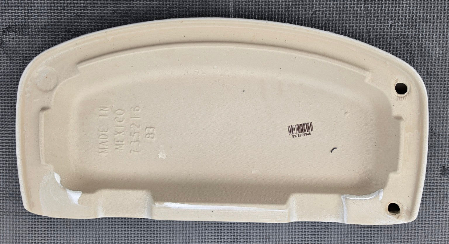 American Standard 735216 white toilet tank lid underside showing molded part number