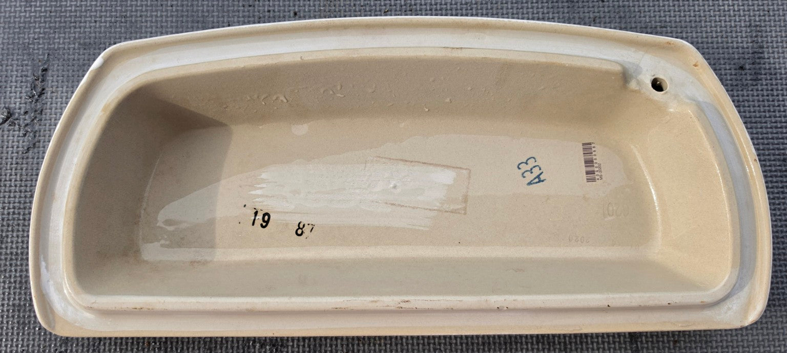 Underside of AquaSource Project Source MT-20202 white toilet tank lid