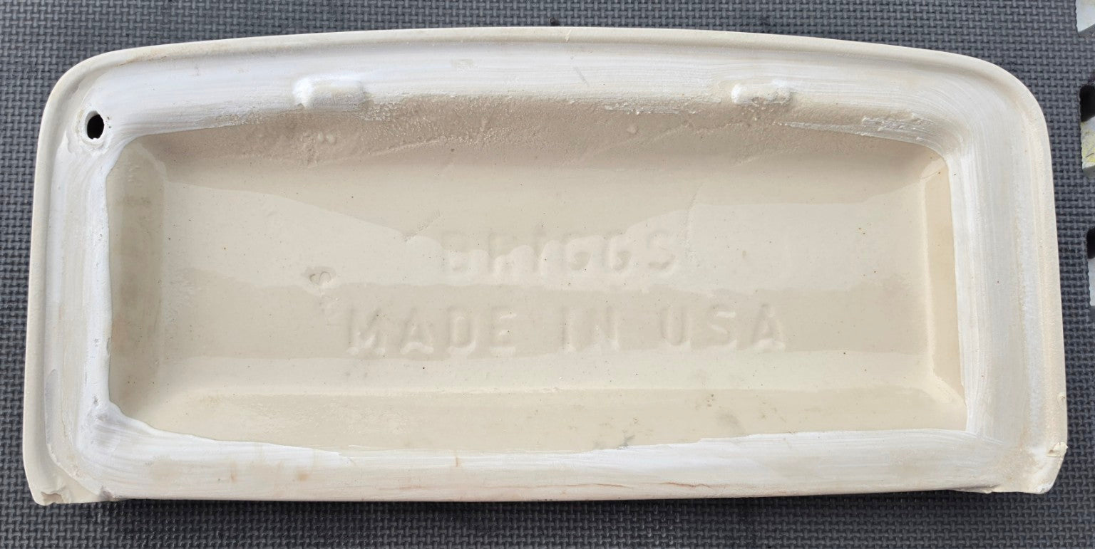 Underside of Briggs 7470 toilet tank lid showing Briggs stamp