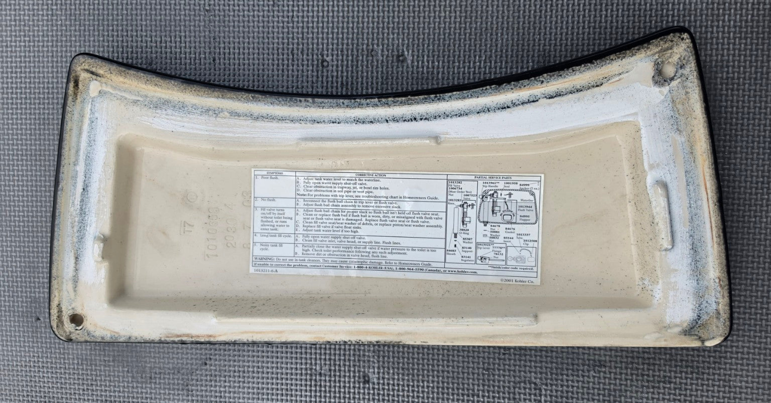 Kohler 1010658 black toilet tank lid underside and stamp