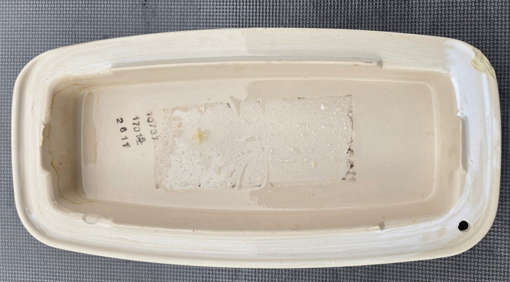 Kohler 1033723 almond toilet tank lid underside showing stamped number