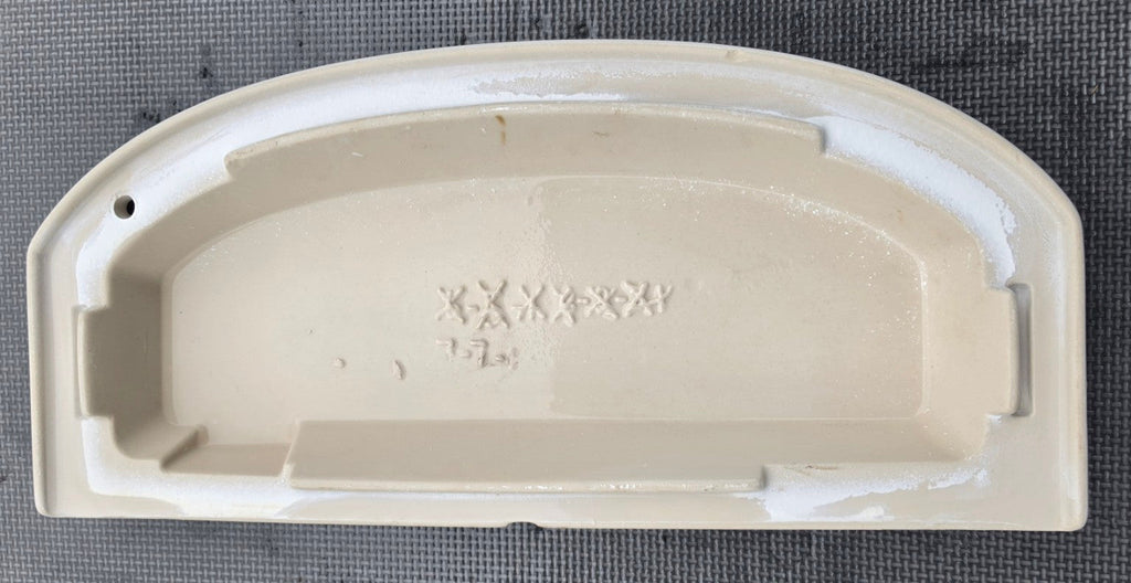 Underside markings and mounting profile of Kohler 1015867 lid for K4634 and K4634HE