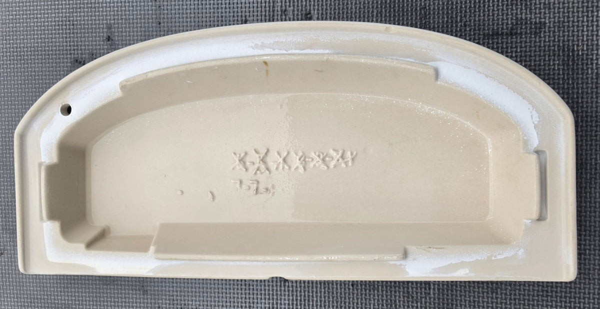 Underside markings and mounting profile of Kohler 1015867 lid for K4634 and K4634HE
