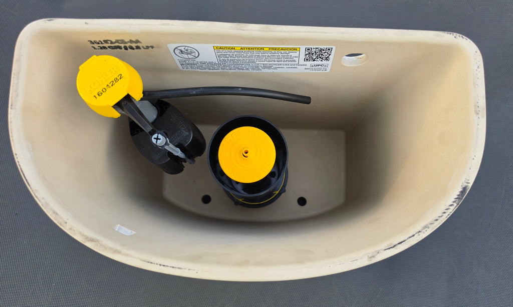 Kohler Maxton white toilet tank interior showing fill valve and flush canister