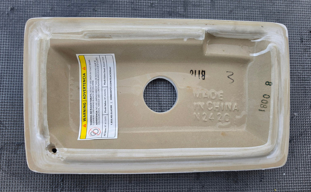 Niagara N2420TL white dual-flush toilet tank lid underside showing N2420 marking, flush button not included
