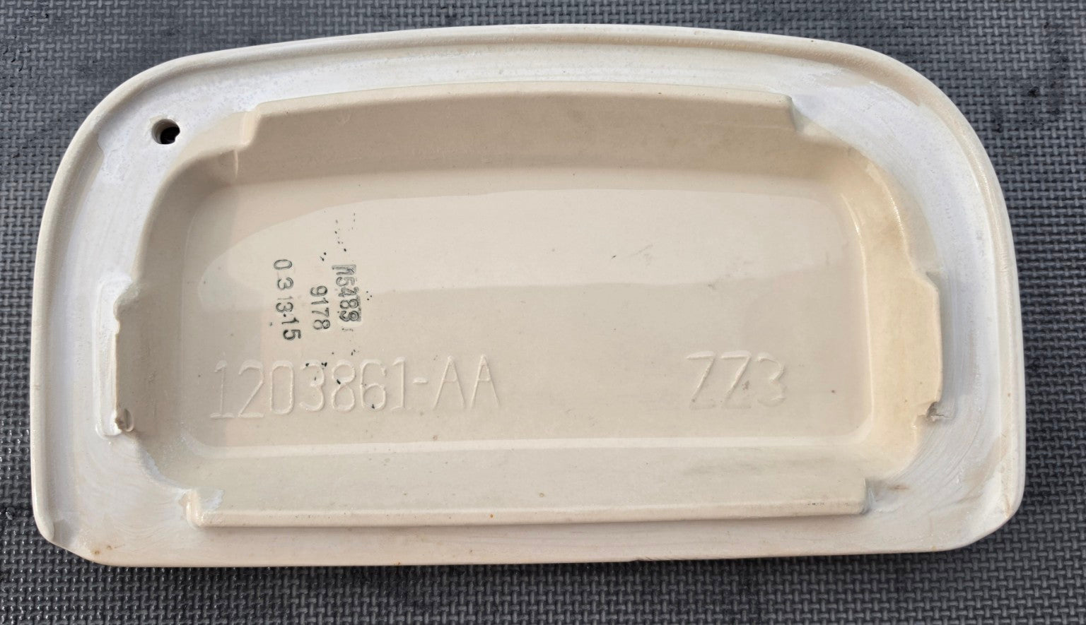 Sterling 1203861-AA toilet tank lid in Biscuit - underside showing model number