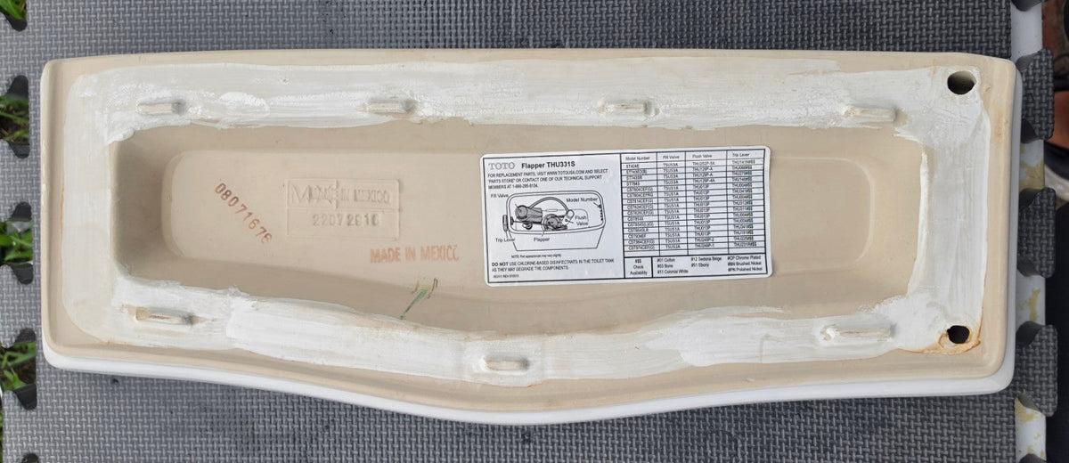 Underside markings of white TOTO ST784 toilet tank lid